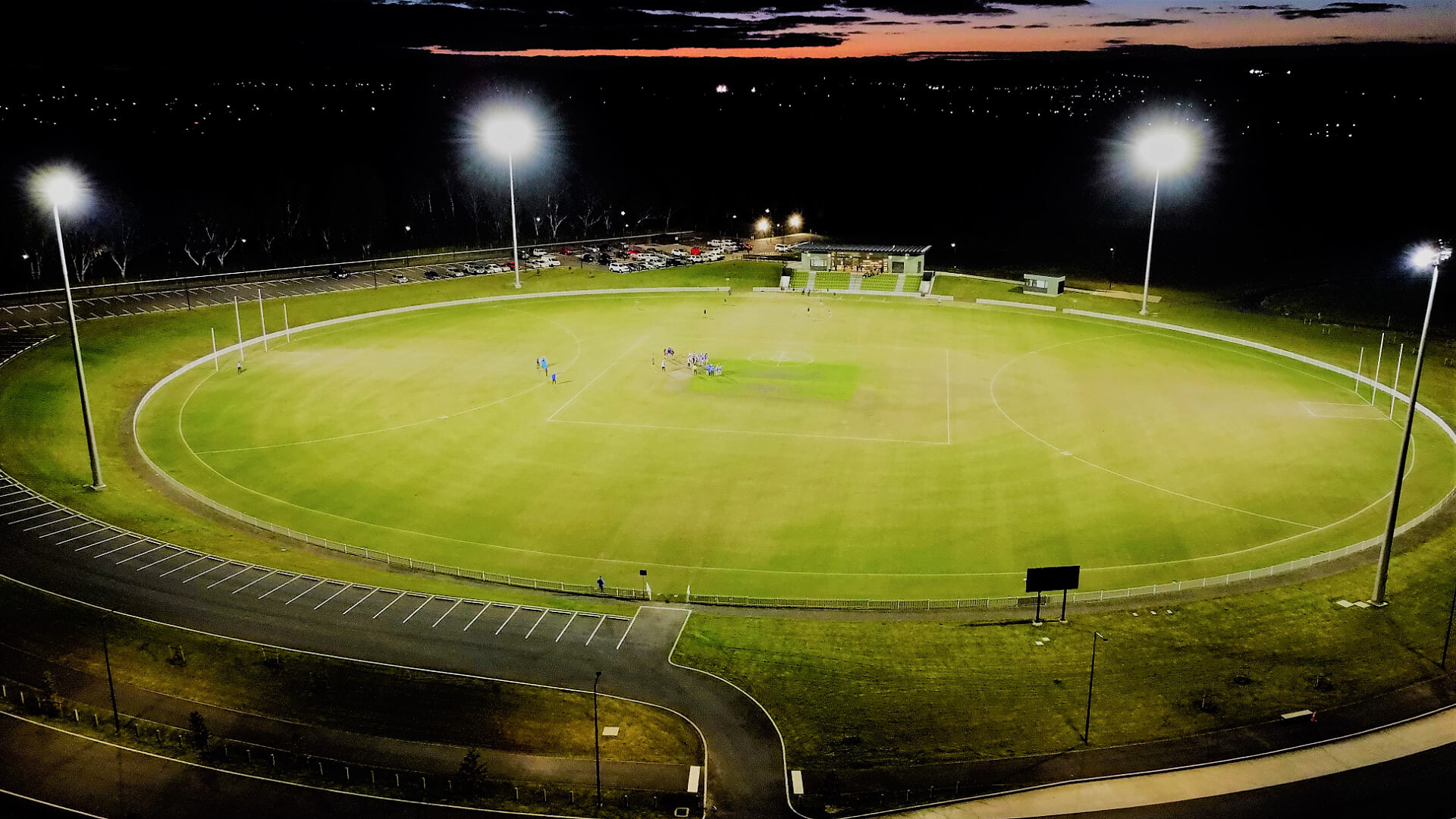 Aerial view of Summit Stadium lit up for a night match